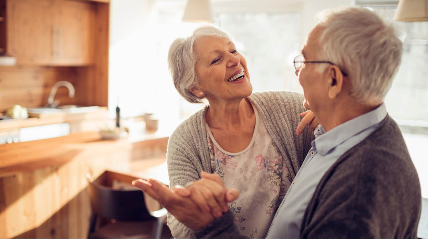 older couple dancing listening to music