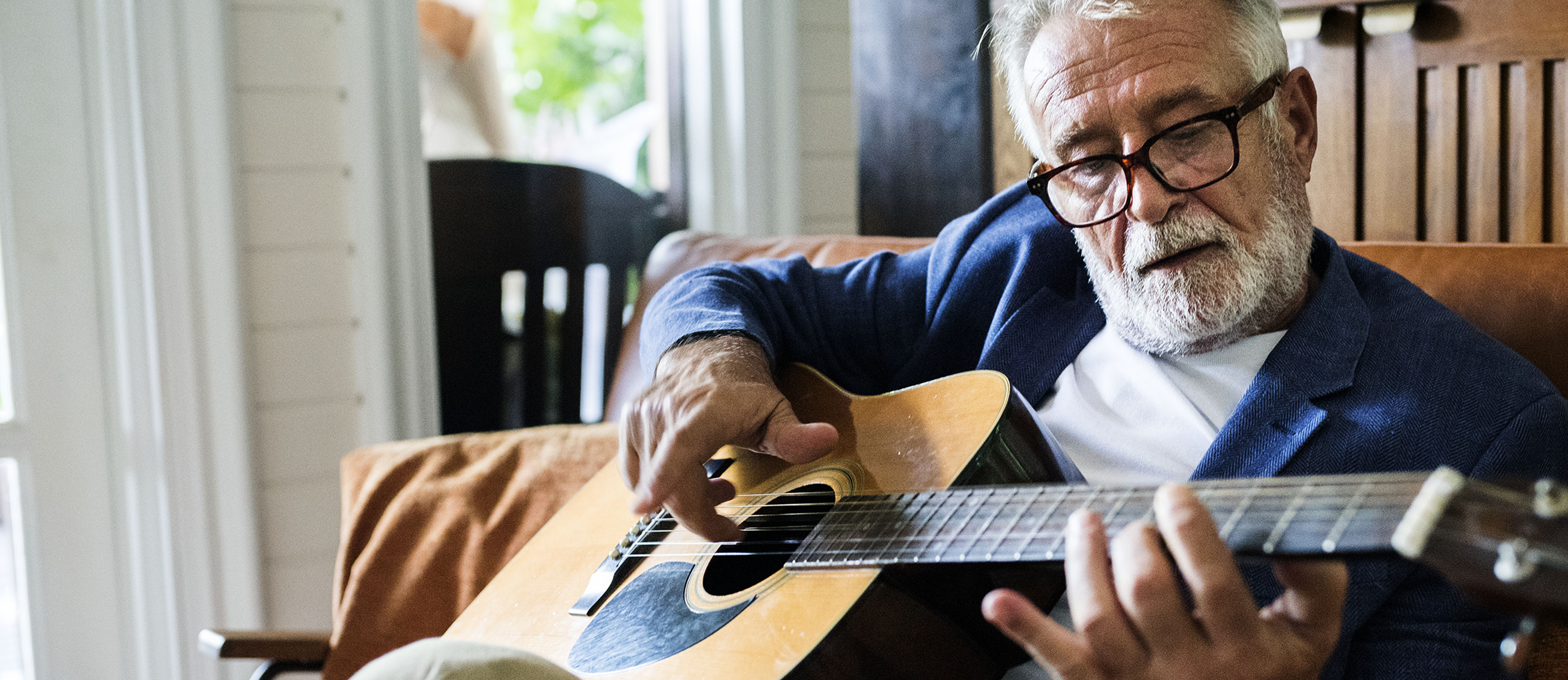 older gentleman playing guitar