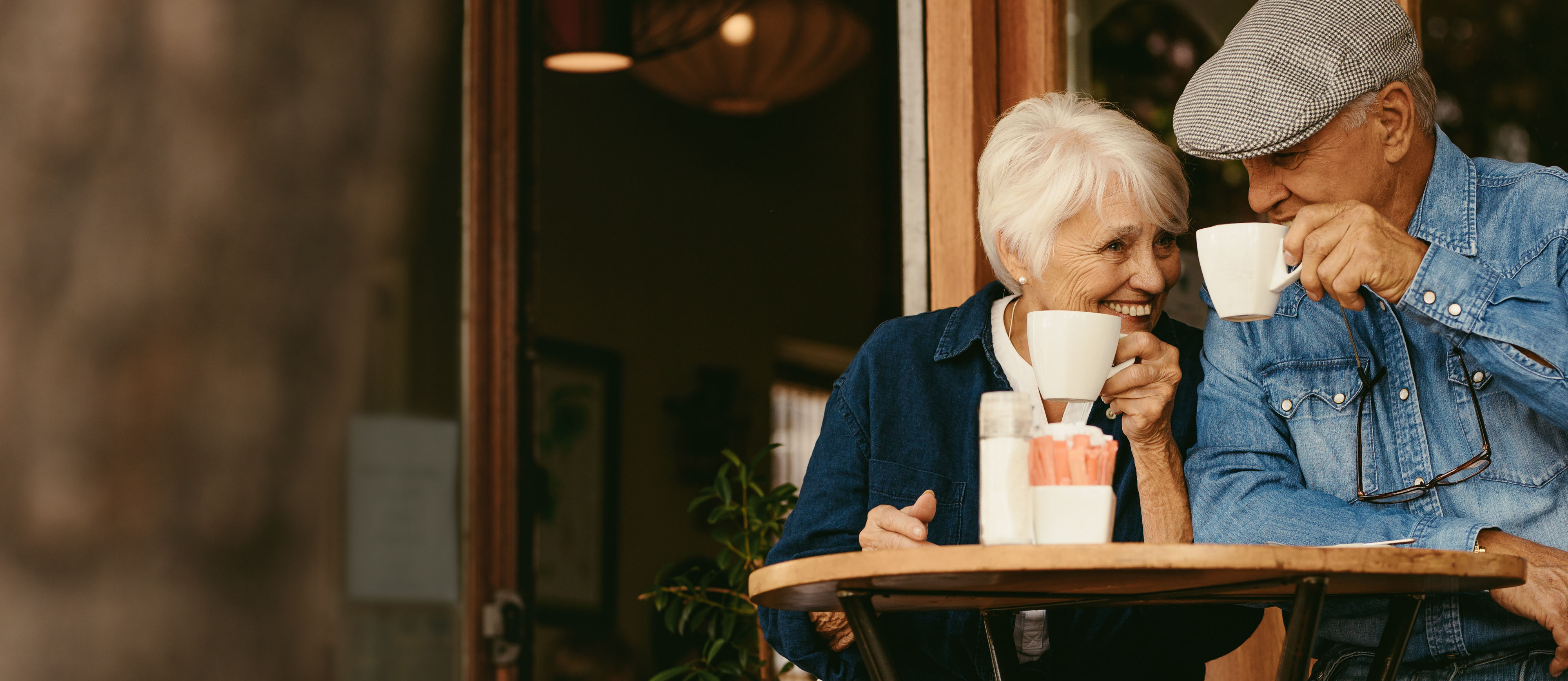 Two elderly couple drinking coffee